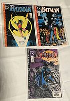 Three Batman comic books featuring issues 440, 441, and 442 from the "A Lonely Place for Dying" storyline, each in plastic sleeves on a white surface.