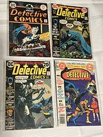 Four vintage Detective Comics issues with Batman covers, arranged in a 2x2 grid, clearly showing the comics' covers and issue numbers.