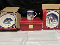 Four Mikasa Skating Bear dishes displayed with boxes, including one mug, one bowl and plates