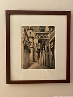 Frontal photo of the framed black and white artwork of La Bodeguita del Medio street scene.