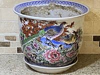 Front side showing colorful peacocks with floral and autumn leaf motifs on the planter.