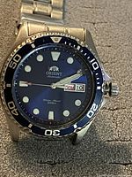 Close-up of full watch face and stainless steel bracelet showing overall condition and design.