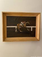 Front view of the framed horse racing painting showing horse number 5 with jockey.
