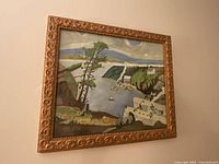 Angled view of harbor scene painting in ornate gold frame hung on wall