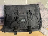 Front view of the Blackhawk Advanced Tactical Briefcase showing main flap with three secured front pockets and Blackhawk patch.