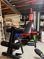 Full view of Bowflex PR1000 system showing bench, resistance rods, pulley assembly and leg attachment