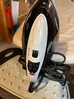 Close-up of the Sunbeam iron showing steam and temperature controls on the handle