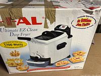 The T-fal branded box showing the product name Ultimate EZ Clean Deep Fryer, with 1700 watt power highlighted and images of fried foods.