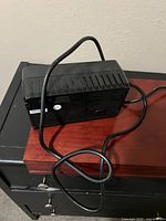 UPS unit top and side view showing power cord and ventilation slits