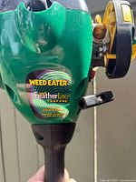 Close-up of Weed Eater Feather Lite SST25C model sticker on green body
