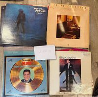Photo of eight vinyl LP record covers including Elvis Presley, Frank Sinatra, Toto, Julio Iglesias, Cher, The Walker Brothers, and Dean Martin.