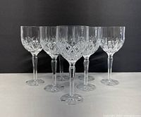 Front view of 7 Marquis by Waterford crystal wine glasses arranged in triangle formation.