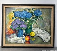 Front view of framed oil painting showing hydrangeas, fruit, cloth and frame