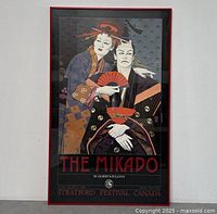 Full view of the framed vintage poster for The Mikado showing two figures dressed in traditional Japanese clothing and event details.