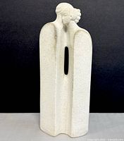 Front view showing abstract couple sculpture in white marble with hollow center.