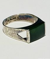 Close-up image of the vintage sterling silver ring with green jade rectangular stone.