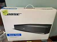 Unopened Bose Solo TV sound system box with handle and branding