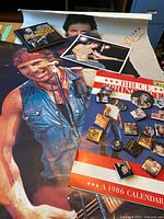 Large Bruce Springsteen poster with a calendar and some pins on top