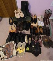 Overview photo of all shoes showing layout and variety including boots, flats, sandals, flip-flops, and heels in various colors and styles.