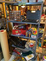 Metal shelving unit shown fully assembled with multiple objects on the shelves, detailing the structure and appearance of the shelves.