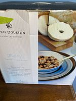 Box front showing Royal Doulton Galaxy branding and image of set with bowl and plate filled with cereal.