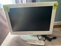 White Samsung 19 inch LCD TV with a stand, showing front screen and body.