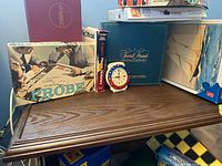 Brown traditional style wood side/end table with items on top to show surface details and size.