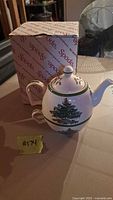 Tea for one set including teapot and cup with Christmas Tree pattern, placed next to original Spode box.