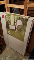 Packaged Zero Gravity Lounge Chair in original box standing upright in basement storage.