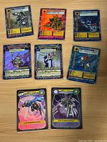 Overview of all seven Digimon trading cards on tabletop