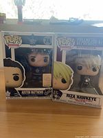 Front view of both sealed Funko Pop figures in boxes: Austin Matthews #74 and Riza Hawkeye #433