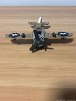 Front view of assembled tan LEGO biplane showing propeller, wings, landing gear