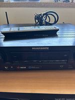Front view of Marantz NR1509 receiver with remote and attached antennas
