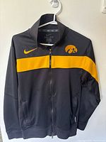 Front view of black/gold Nike Iowa Hawkeyes full-zip jacket