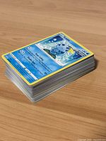 Centered stack of Pokémon cards with Manaphy on top