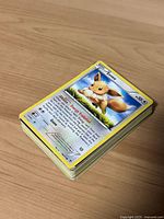 Stack of Pokémon cards with Eevee on top