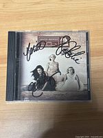 Front of jewel case showing signed album cover