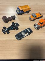 Overall view of six die-cast vehicles on tabletop