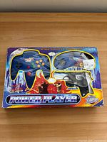Front of boxed Power Player console showing window with controllers and gun