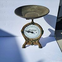 Front view of vintage decorative family scale showing dial labelled 'Family Scale' and ornate base details