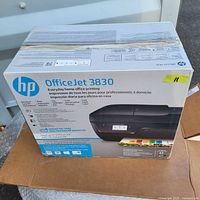 Boxed HP OfficeJet 3830 printer showing front with logo and product image.