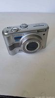 Front view of silver Panasonic Lumix DMC-LZ5 digital camera showing lens and shutter button.