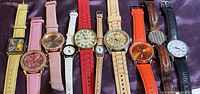 All ten assorted wristwatches laid out