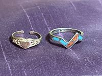 Top view of both sterling silver rings showing inlay chevron ring and heart ring fronts