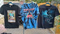 Front view of three graphic T-shirts hanging: Idaho Springs, Pink Floyd tie-dye, Tron