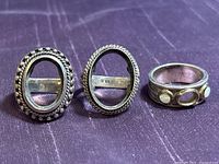 Front view of three sterling silver ring settings showing bezels