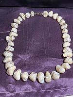 Full view of abalone shell nugget necklace laid out in circle