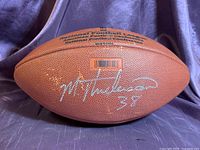 Autograph side showing silver signature and number 38 on football