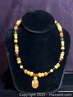 Necklace on display bust showing bead pattern and pendant