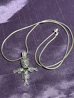 Pendant and chain laid flat showing design and clasp